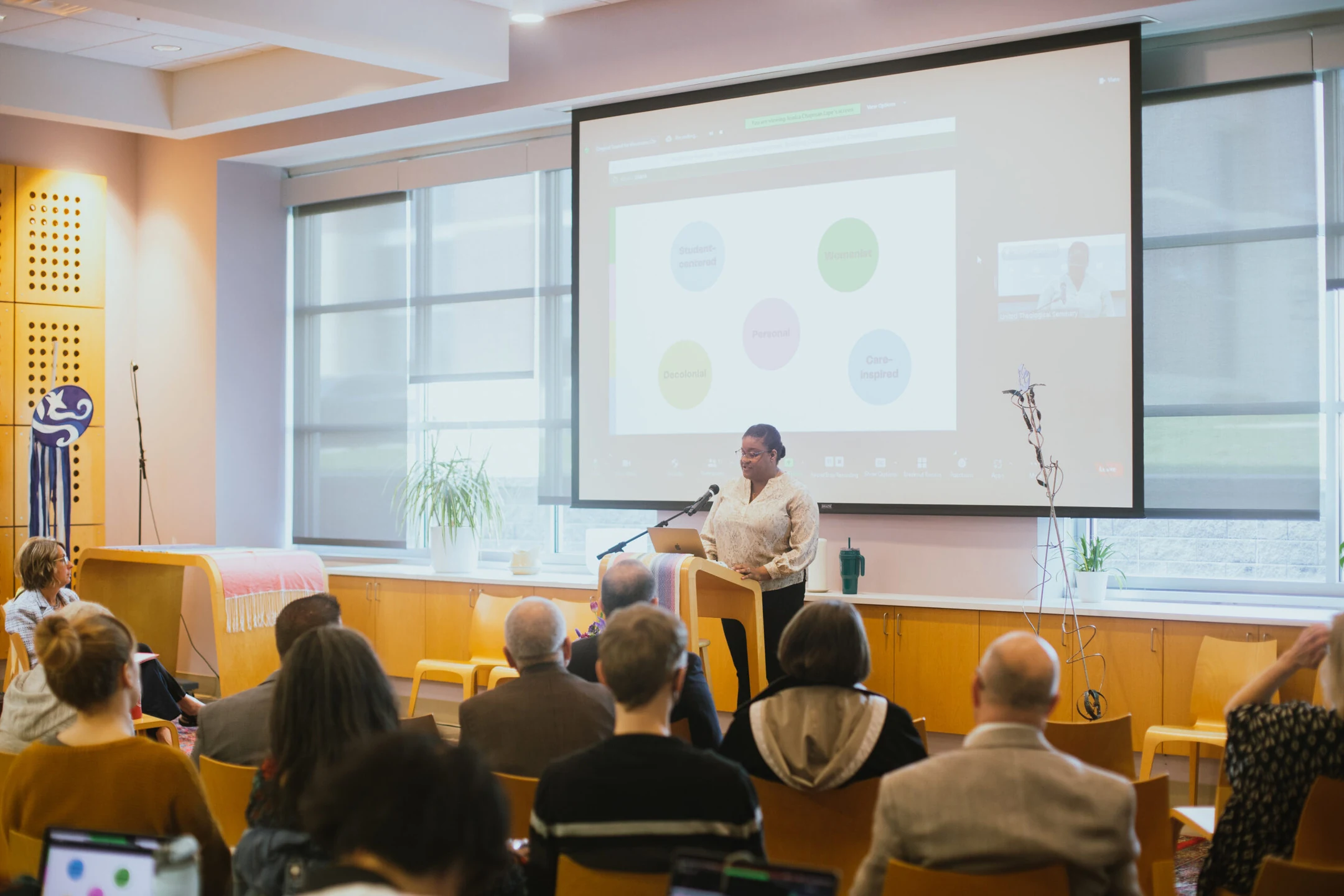 A photo of Rev. Dr. Jessica Chapman Lape giving a lecture.