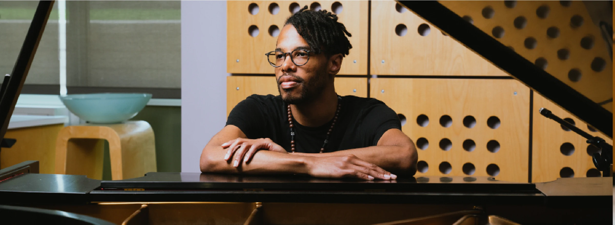 A photo of a student at a piano.