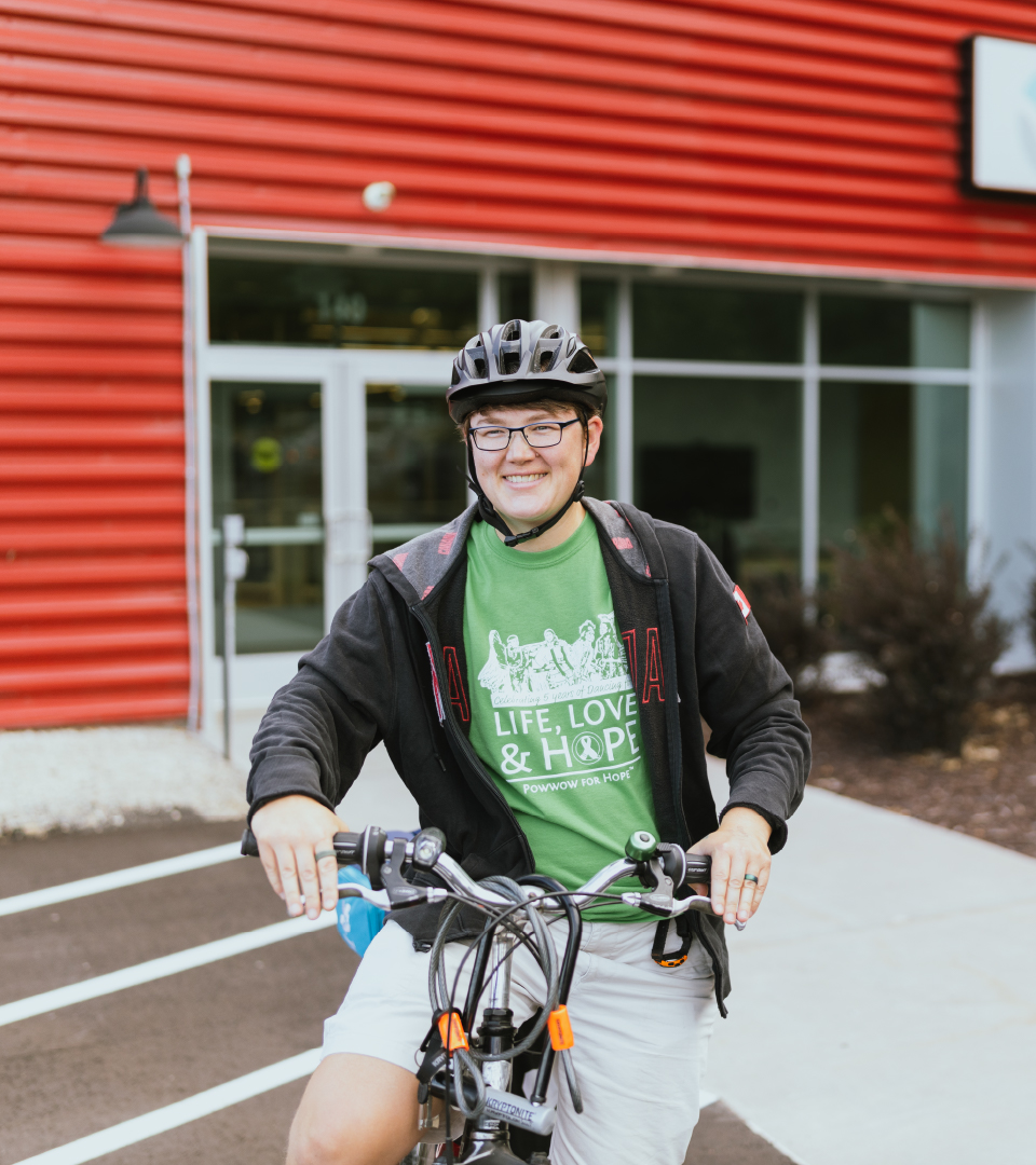 A photo of student on a bike.