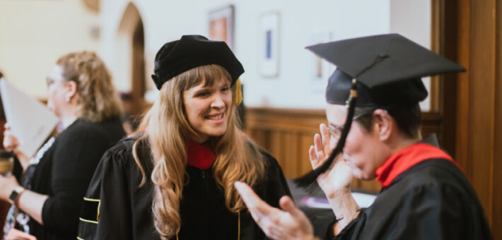 A faculty member and a graduate speak.