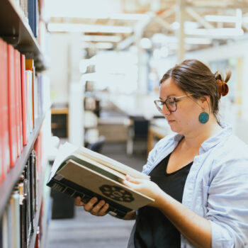 A student reads a book in the library.