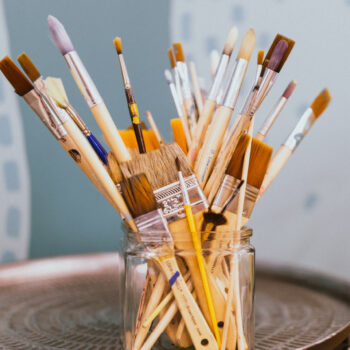 A photo of paint brushes in a jar.