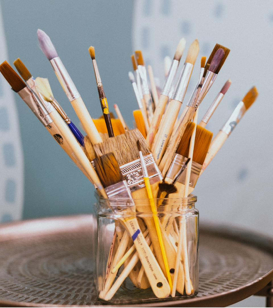 A photo of paint brushes in a jar.