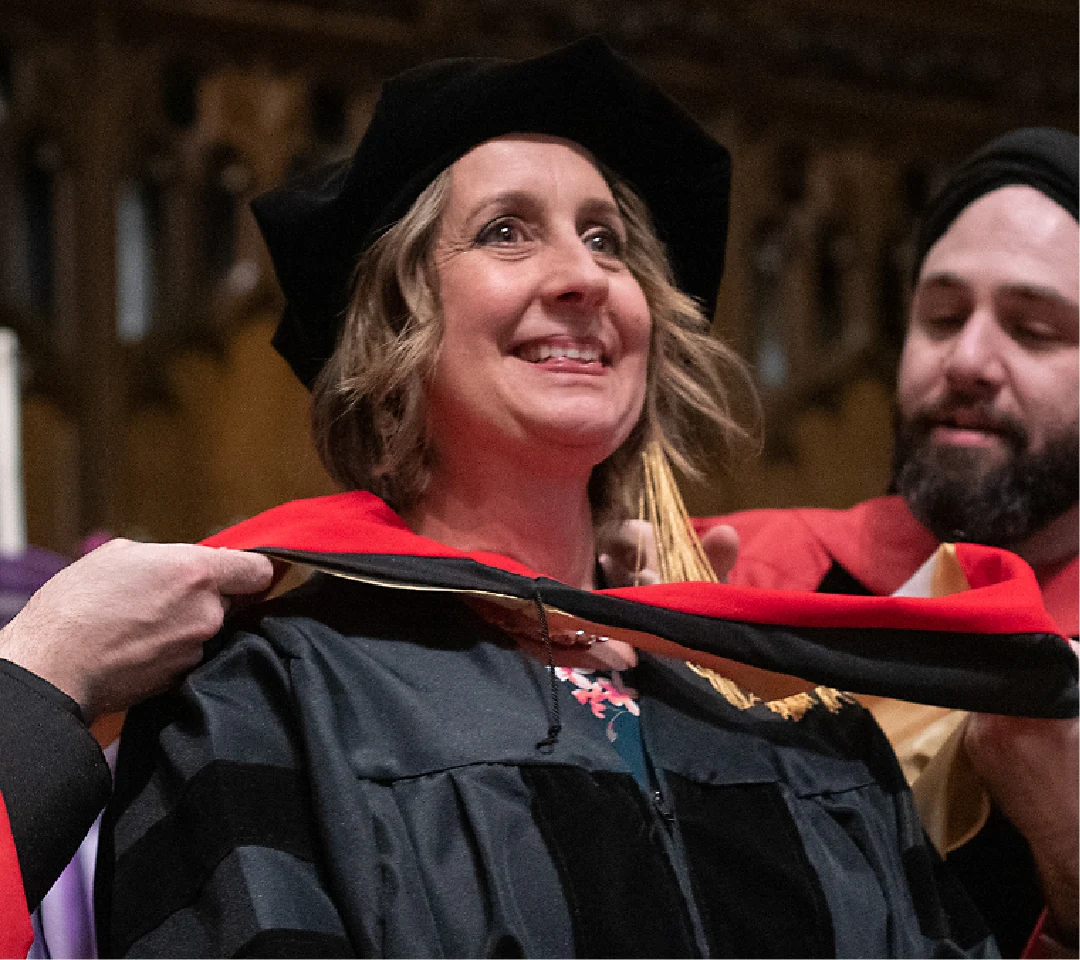 A photo of a DMin graduate receiving her hood.